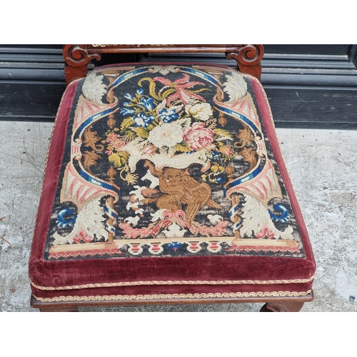 1063 - A Victorian walnut and petit point prie dieu chair.