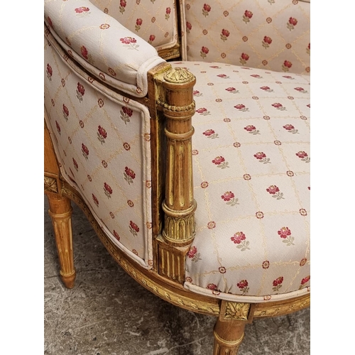 1065 - A Louis XVI style carved giltwood fauteuil.