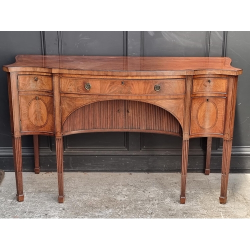 1069 - A George III mahogany, line inlaid and crossbanded serpentine fronted sideboard, 153cm wide.... 