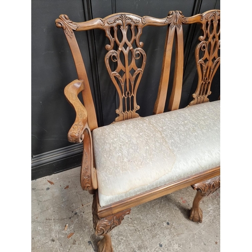 1071 - A George III style carved mahogany chairback settee, 118.5cm wide.