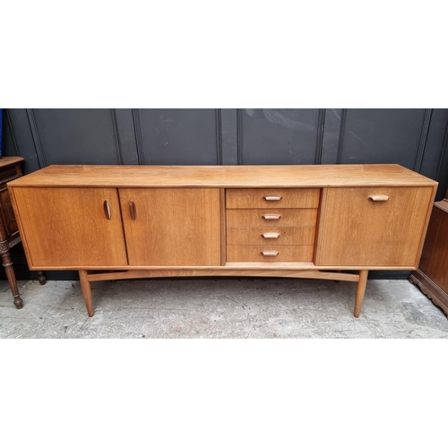 1073 - A mid-century G Plan teak sideboard, 208cm wide.