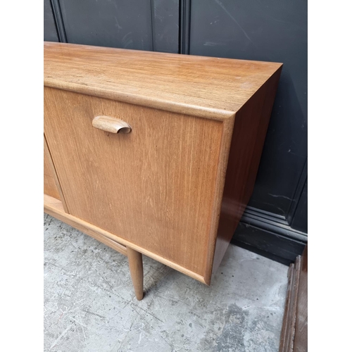 1073 - A mid-century G Plan teak sideboard, 208cm wide.