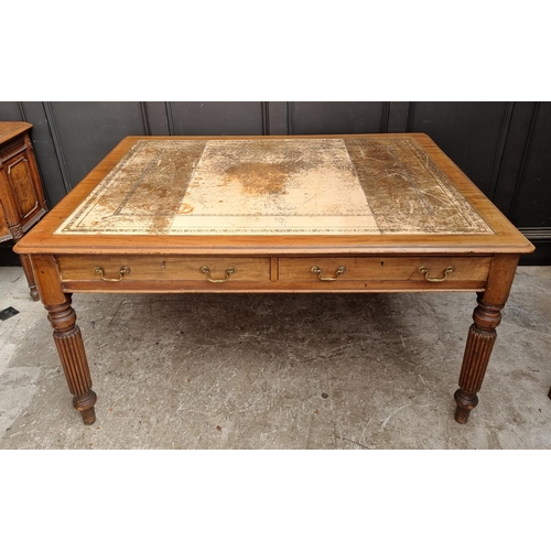 1075 - An early 19th century mahogany partners' desk, on reeded legs, 119 x 152cm.