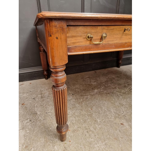 1075 - An early 19th century mahogany partners' desk, on reeded legs, 119 x 152cm.