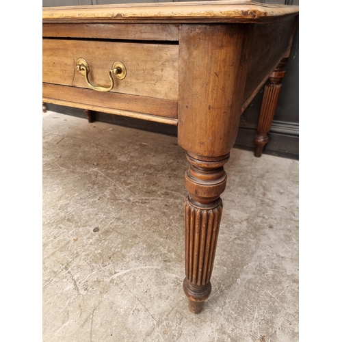 1075 - An early 19th century mahogany partners' desk, on reeded legs, 119 x 152cm.