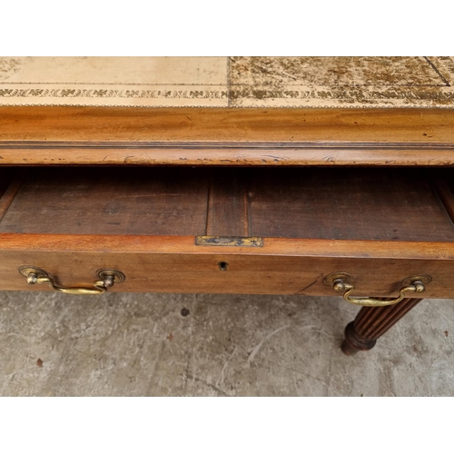 1075 - An early 19th century mahogany partners' desk, on reeded legs, 119 x 152cm.