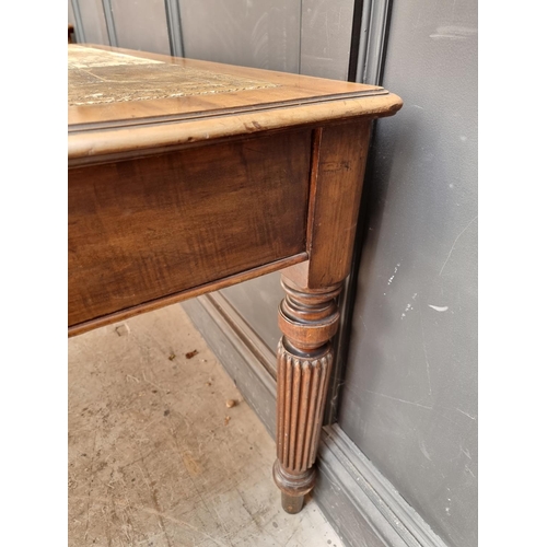 1075 - An early 19th century mahogany partners' desk, on reeded legs, 119 x 152cm.