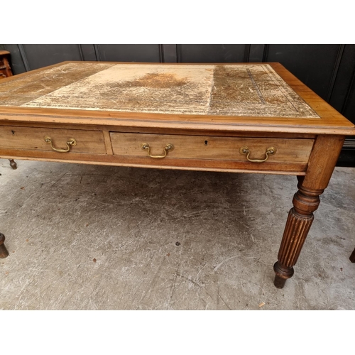 1075 - An early 19th century mahogany partners' desk, on reeded legs, 119 x 152cm.