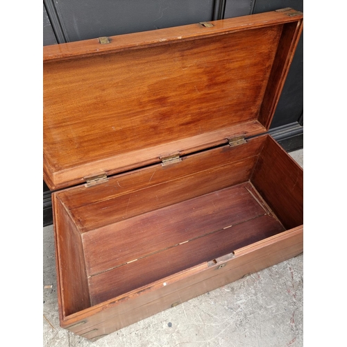 1077 - A late 19th century teak and brass bound chest, 94cm wide.