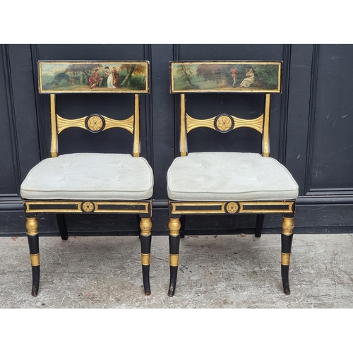 1078 - A pair of Regency ebonized, parcel gilt and painted bar back dining chairs, with cane seats.... 