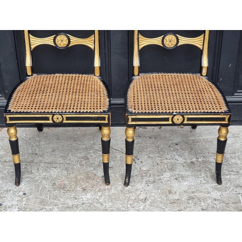 1078 - A pair of Regency ebonized, parcel gilt and painted bar back dining chairs, with cane seats.... 