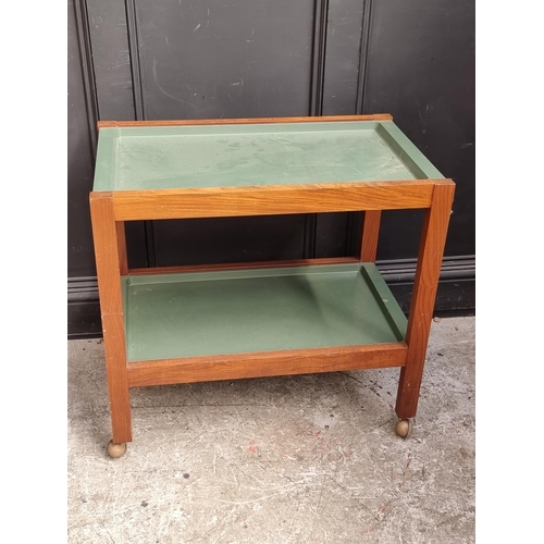 1088 - A mid-century teak two-tier tea trolley, with detachable green trays, 76cm wide.