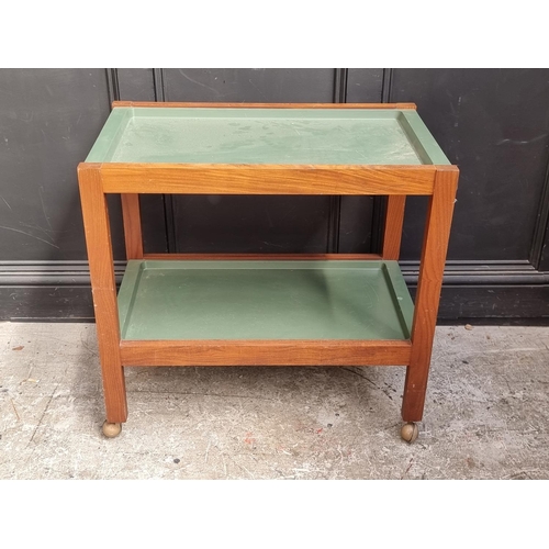 1088 - A mid-century teak two-tier tea trolley, with detachable green trays, 76cm wide.