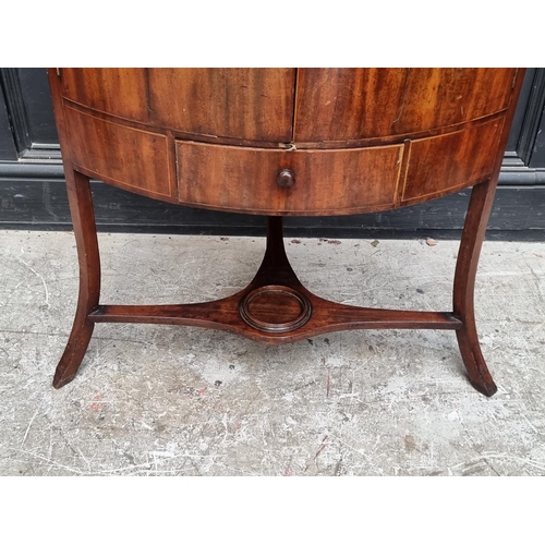 1093 - A George III mahogany corner wash stand, with hinged splashback, 67.5cm wide.