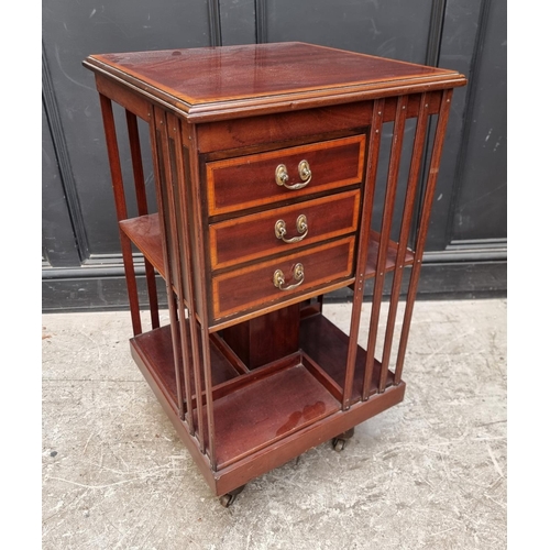 1094 - A late Victorian mahogany, satinwood crossbanded and line inlaid revolving bookcase, with three... 