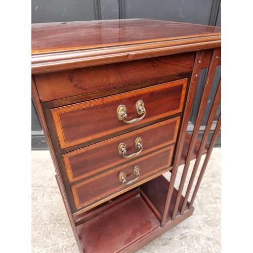 1094 - A late Victorian mahogany, satinwood crossbanded and line inlaid revolving bookcase, with three... 