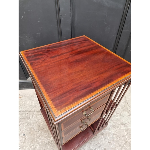 1094 - A late Victorian mahogany, satinwood crossbanded and line inlaid revolving bookcase, with three... 