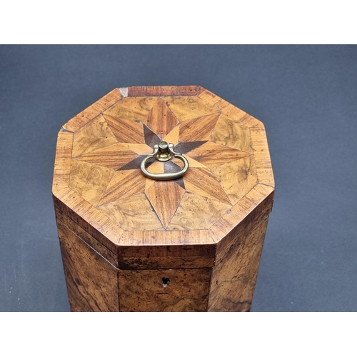 1125 - A George III figured walnut and parquetry octagonal tea caddy, 14.5cm high, with key.... 