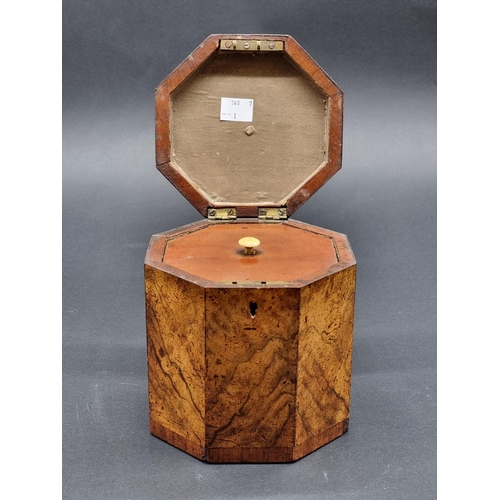 1125 - A George III figured walnut and parquetry octagonal tea caddy, 14.5cm high, with key.... 