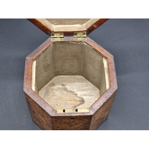 1125 - A George III figured walnut and parquetry octagonal tea caddy, 14.5cm high, with key.... 