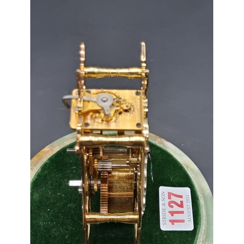 1127 - A small brass skeleton timepiece, by Thwaites & Reed, numbered 201/1000T, with glass dome and gr... 