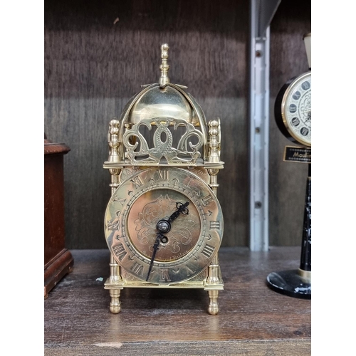 1130 - Four vintage timepieces, to include a brass lantern clock style example, 17.5cm high. (4)... 