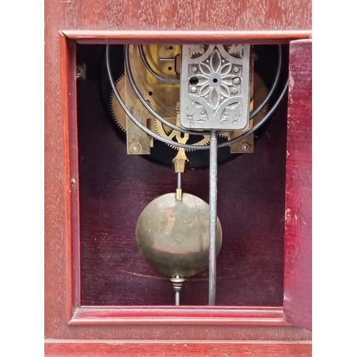 1137 - An Edwardian mahogany and inlaid mantel clock, 31.5cm high, with pendulum.