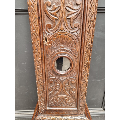 1138 - An 18th century and later carved oak eight day longcase clock, the 10 1/2in square brass and silvere... 