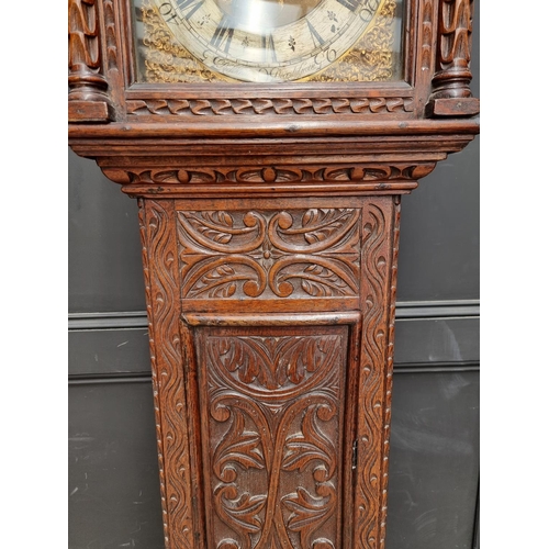 1138 - An 18th century and later carved oak eight day longcase clock, the 10 1/2in square brass and silvere... 