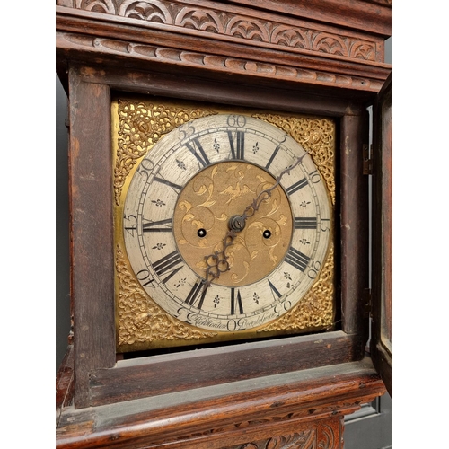 1138 - An 18th century and later carved oak eight day longcase clock, the 10 1/2in square brass and silvere... 