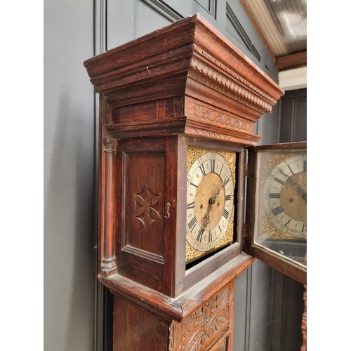 1138 - An 18th century and later carved oak eight day longcase clock, the 10 1/2in square brass and silvere... 