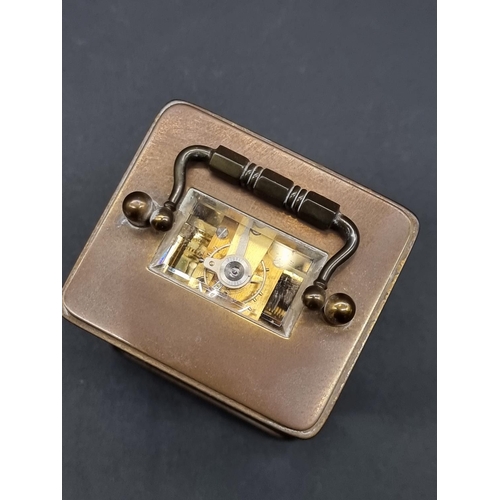 1148 - A miniature brass carriage timepiece, height including handle 10.5cm, with winding key.... 