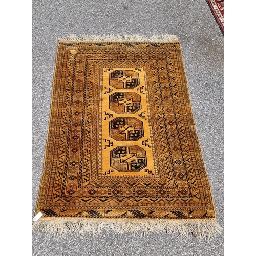 1155 - An Afghan rug, having four central medallions, on yellow ground, 210 x 135cm.