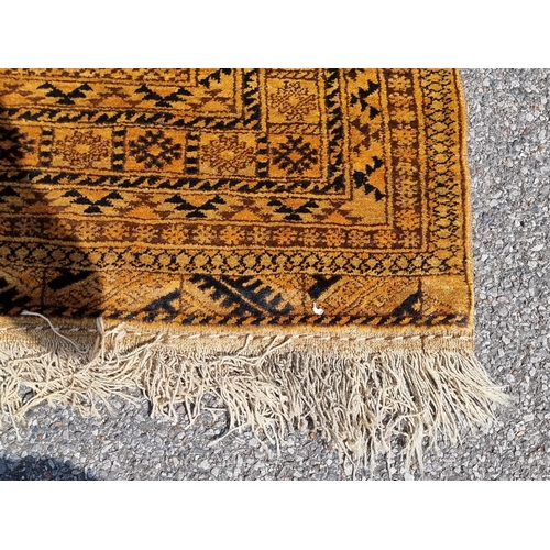 1155 - An Afghan rug, having four central medallions, on yellow ground, 210 x 135cm.