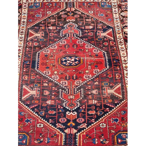 1159 - A Persian rug, having allover geometric design, with floral borders, 227 x 149cm.