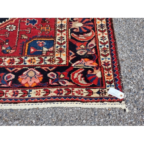 1159 - A Persian rug, having allover geometric design, with floral borders, 227 x 149cm.