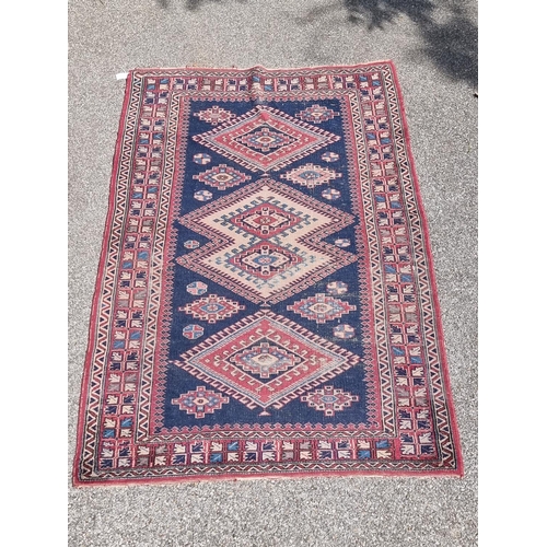 1162 - A Persian rug, having three diamond medallions, with geometric border, 208 x 130cm.