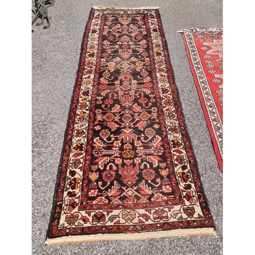 1164 - A Persian runner, having floral central field; together with a small Persian rug, having three centr... 