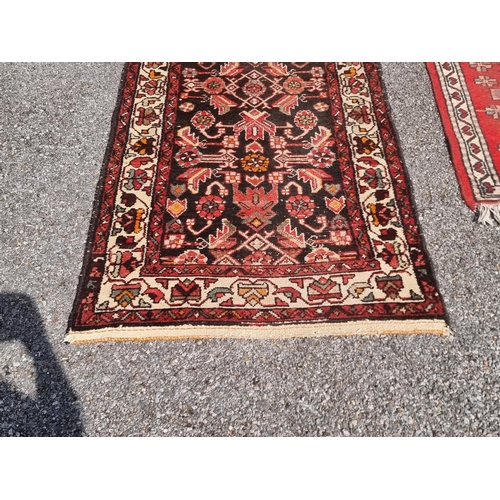 1164 - A Persian runner, having floral central field; together with a small Persian rug, having three centr... 