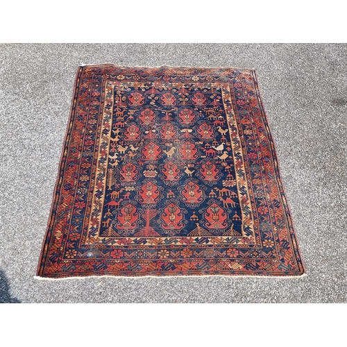 1165 - A Persian rug, central field decorated with birds and camels, with floral and geometric borders, 202... 