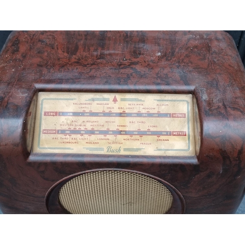 1340 - A Bush brown Bakelite radio; together with an old telephone. (2)