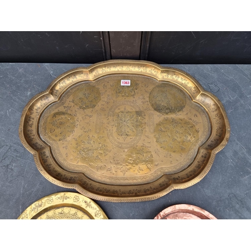 1363 - An Eastern brass tray, 60cm wide; together with a Persian brass plate, 26.5cm diameter; and an ... 