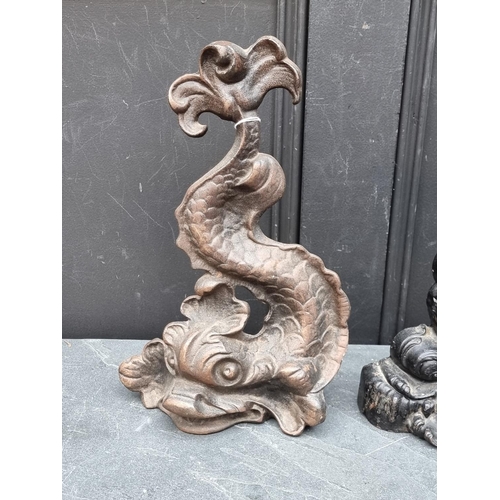 1366 - Two Victorian cast iron dolphin doorstops, largest 37.5cm high.