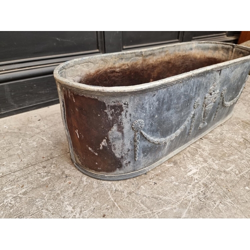 1377 - An old lead oval planter, 78cm wide.