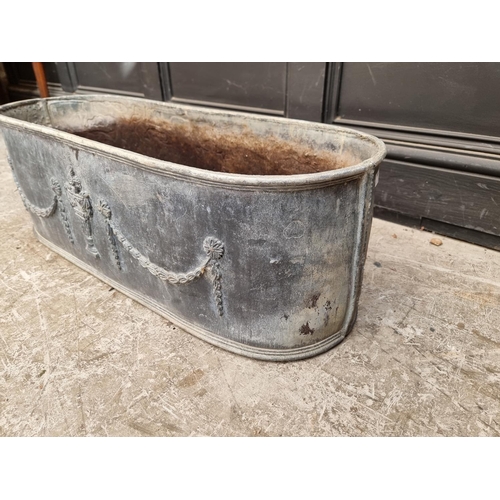 1377 - An old lead oval planter, 78cm wide.