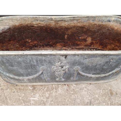 1377 - An old lead oval planter, 78cm wide.