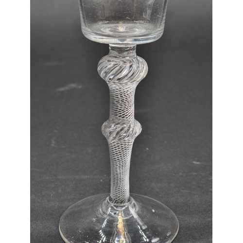 1389 - An 18th century air twist double knop wine glass, 17.7cm.