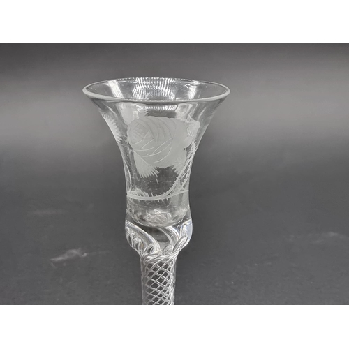 1395 - An 18th century Jacobite air twist wine glass, the bowl engraved with a rose, bud and leaves, 1... 