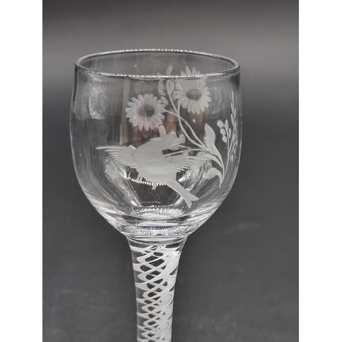 1401 - An 18th century double series opaque twist wine glass, the bowl engraved with a bird and flower... 