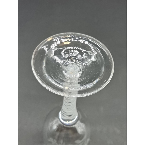 1401 - An 18th century double series opaque twist wine glass, the bowl engraved with a bird and flower... 